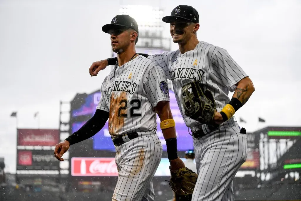 DENVER, CO – SEPTEMBER 3: Brenton Doyle #9 of the Colorado Rockies puts his arm around teammate Nolan Jones #22 as they return to the dugout as a rain delay is called as heavy rain falls in the top of the fifth inning of a game against the Toronto Blue Jays at Coors Field on September 3, 2023 in Denver, Colorado. (Photo by Dustin Bradford/Getty Images)