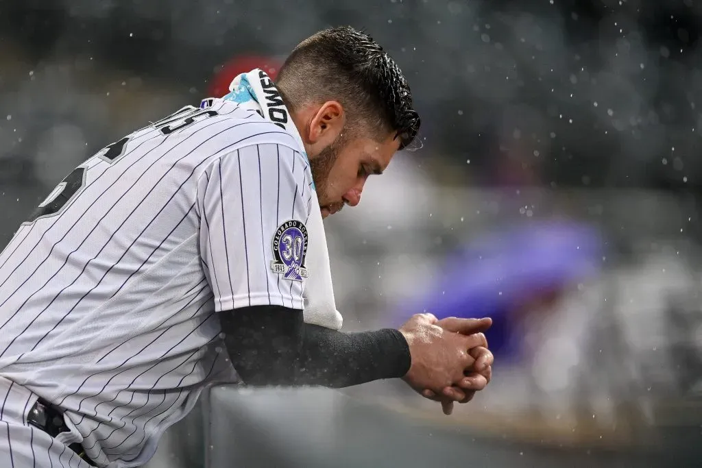 DENVER, CO – SEPTEMBER 3: Austin Wynns #16 of the Colorado Rockies looks on from the dugout as rain falls in the ninth inning of a game against the Toronto Blue Jays at Coors Field on September 3, 2023 in Denver, Colorado. (Photo by Dustin Bradford/Getty Images)