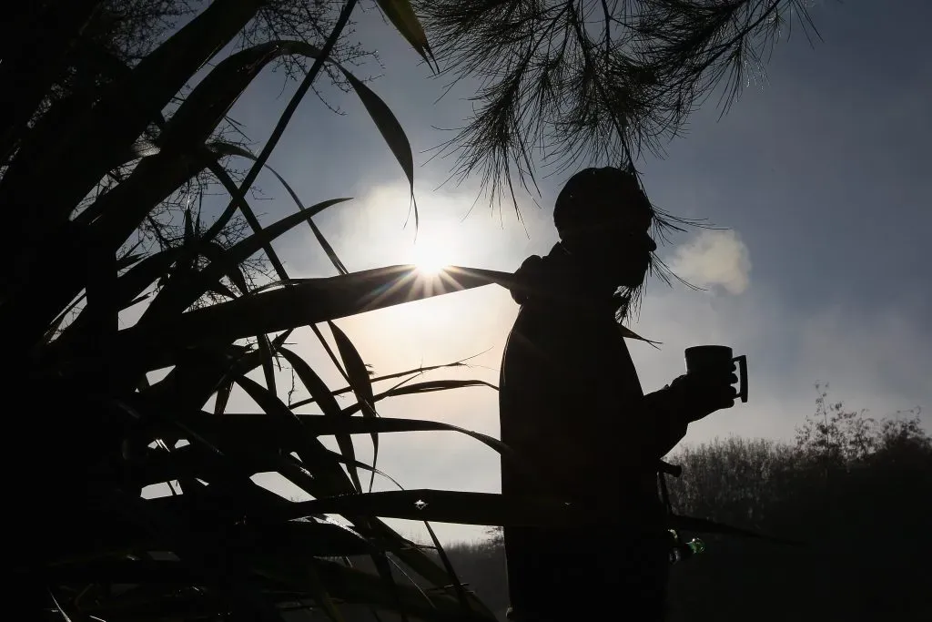 POKENO, NEW ZEALAND – MAY 05:  Ben Staeffens enjoys a cup of coffee while on duck watch at Blythen Wetlands on May 5, 2012 in Pokeno, New Zealand. As the duck shooting season opens today, authorities are urging shooters to take care.  (Photo by Sandra Mu/Getty Images)