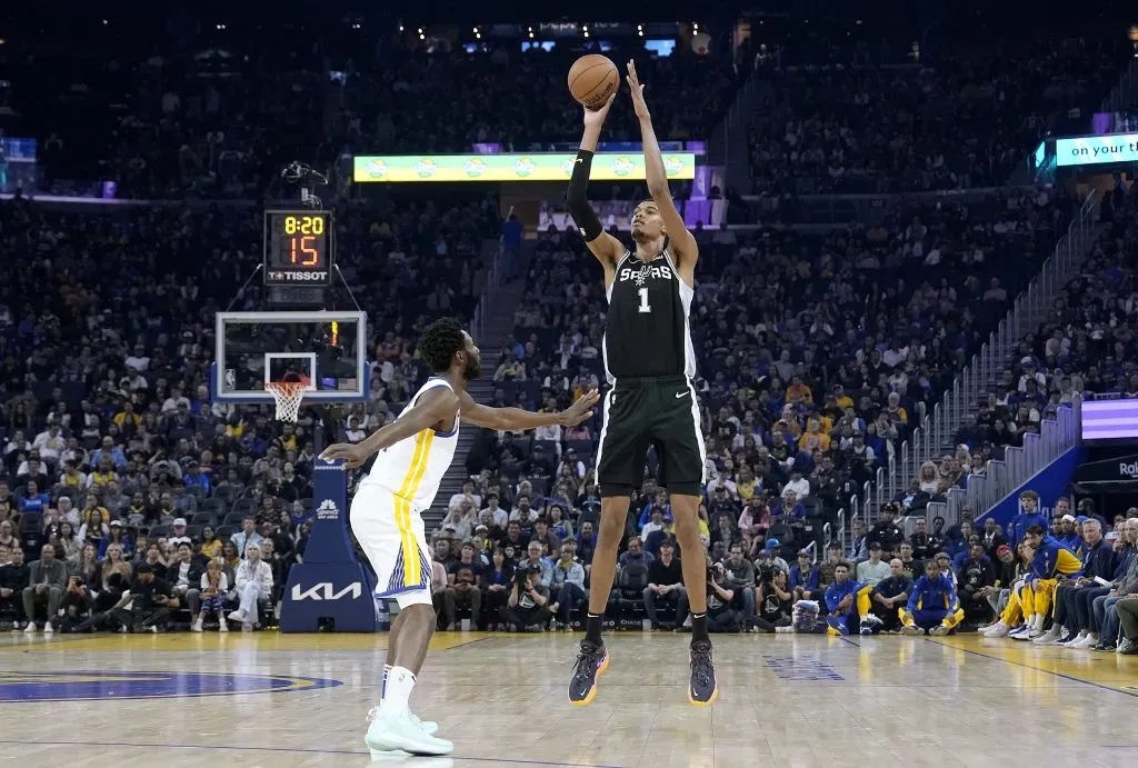 Victor Wembanyama #1 of the San Antonio Spurs shoots the ball against Andrew Wiggins #22 of the Golden State Warriors. Thearon W. Henderson/Getty Images