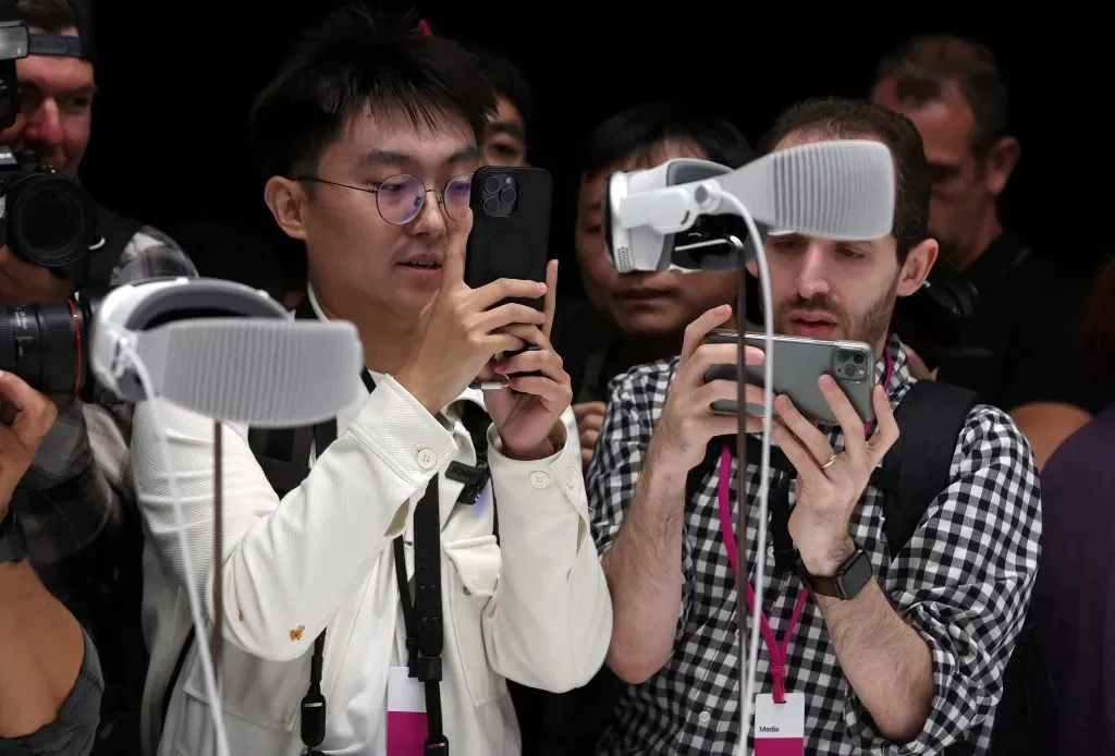 CUPERTINO, CALIFORNIA – JUNE 05: Members of the media inspect the new Apple Vision Pro headset during the Apple Worldwide Developers Conference on June 05, 2023 in Cupertino, California. Apple CEO Tim Cook kicked off the annual WWDC22 developer conference with the announcement of the new Apple Vision Pro mixed reality headset. (Photo by Justin Sullivan/Getty Images)