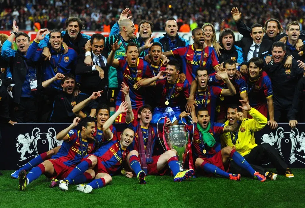 Lionel Messi and Daniel Alves of Barcelona hold the trophy as the team pose for photographs after victory in the UEFA Champions League final. Jasper Juinen/Getty Images