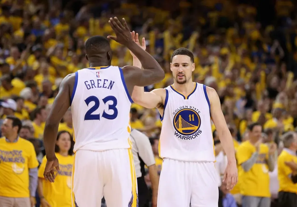 Klay Thompson #11 and Draymond Green #23 of the Golden State Warriors celebrate in the final minute of their victory over the Portland Trail Blazers. Ezra Shaw/Getty Images