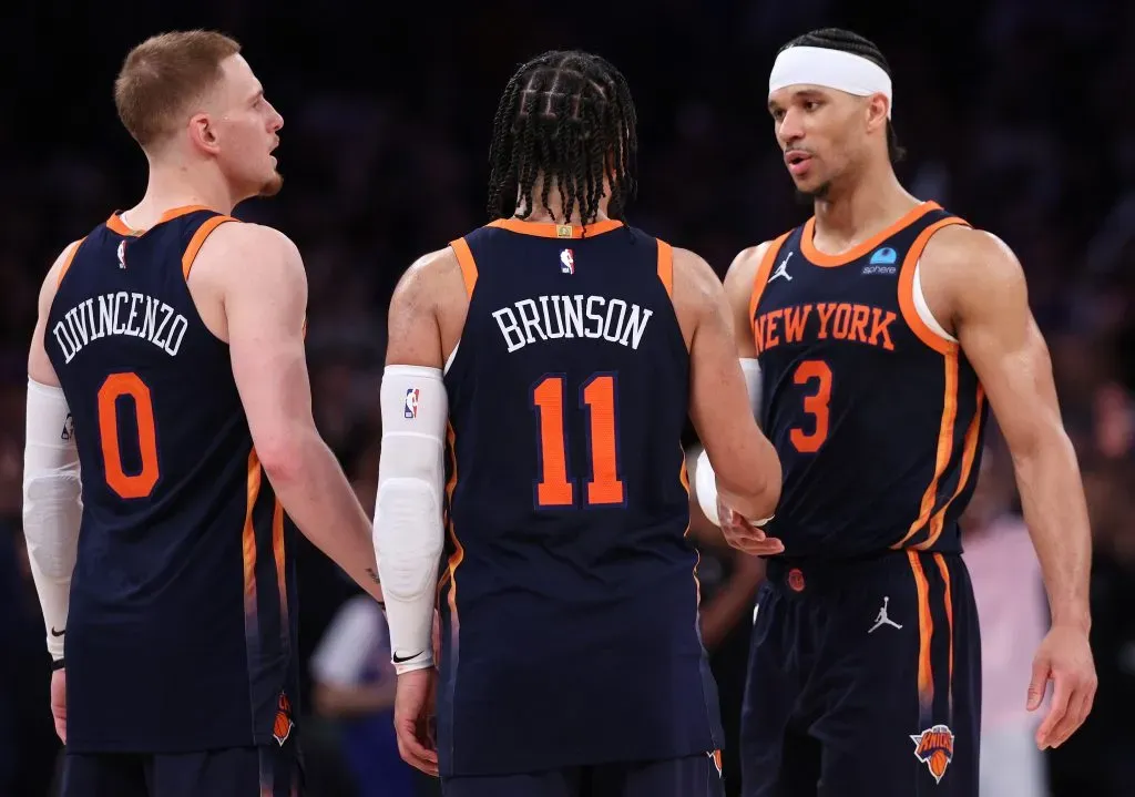 Donte DiVincenzo #0, Jalen Brunson #11 and Josh Hart #3 of the New York Knicks celebrate their win against the Indiana Pacers in Game Two.  Elsa/Getty Images