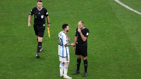 LUSAIL CITY, QATAR - DECEMBER 09: Referee Antonio Mateu speaks to Lionel Messi of Argentina as they leave the pitch for half time during the FIFA World Cup Qatar 2022 quarter final match between Netherlands and Argentina at Lusail Stadium on December 09, 2022 in Lusail City, Qatar. (Photo by Elsa/Getty Images)