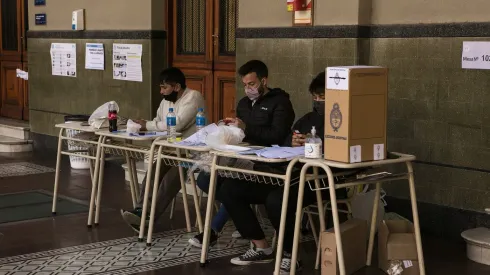 BUENOS AIRES, ARGENTINA, SEPTEMBER 12: Polling station authorities wait for citizens to cast their vote during midterm primary elections on September 12, 2021 in Buenos Aires, Argentina. With health protocols and restrictions to prevent contagion Argentinians are heading to polls amid the COVID-19 pandemic. (Photo by Ricardo Ceppi / Getty Images)