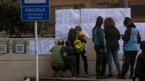 BUENOS AIRES, ARGENTINA, SEPTEMBER 12: A family consults the electoral roll to cast their vote in a school during midterm primary elections on September 10, 2021 in Buenos Aires, Argentina. With health protocols and restrictions to prevent contagion Argentinians are heading to polls amid the COVID-19 pandemic. (Photo by Ricardo Ceppi / Getty Images)