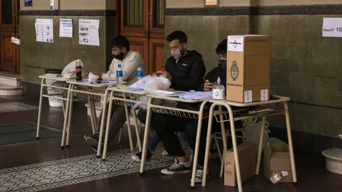 BUENOS AIRES, ARGENTINA, SEPTEMBER 12: Polling station authorities wait for citizens to cast their vote during midterm primary elections on September 12, 2021 in Buenos Aires, Argentina. With health protocols and restrictions to prevent contagion Argentinians are heading to polls amid the COVID-19 pandemic. (Photo by Ricardo Ceppi / Getty Images)