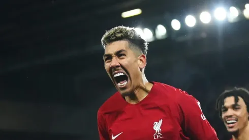 LIVERPOOL, ENGLAND – MARCH 05: Roberto Firmino of Liverpool celebrates after scoring the team's seventh goal with teammate Trent Alexander-Arnold during the Premier League match between Liverpool FC and Manchester United at Anfield on March 05, 2023 in Liverpool, England. (Photo by Michael Regan/Getty Images)