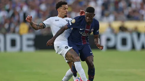 PASADENA, CALIFORNIA – JUNE 19: Nuno Mendes #25 of Paris Saint-Germain is challenged by Gregore #26 of Botafogo during the FIFA Club World Cup 2025 group B match between Paris Saint-Germain FC and Botafogo FR at Rose Bowl Stadium on June 19, 2025 in Pasadena, California. (Photo by Stu Forster/Getty Images)