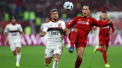 DOHA, QATAR – DECEMBER 21: Virgil van Dijk of Liverpool controls the ball as he is put under pressure by Giorgian De Arrascaeta of CR Flamengo during the FIFA Club World Cup Qatar 2019 Final between Liverpool FC and CR Flamengo at Education City Stadium on December 21, 2019 in Doha, Qatar. (Photo by Francois Nel/Getty Images)