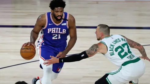 Joel Embiid dribbling past Daniel Theis. (Getty)
