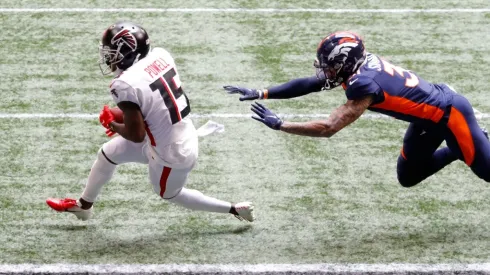 Brandon Powell (left) of the Atlanta Falcons scores a receiving touchdown against Justin Simmons (right) of the Denver Broncos. (Getty)