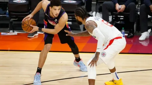 Paul George guarding Devin Booker. (Getty)