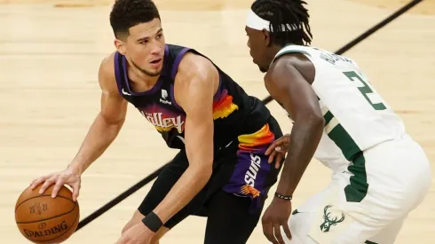 Devin Booker #1 of the Phoenix Suns handles the ball against Jrue Holiday #21 of the Milwaukee Bucks (Getty)