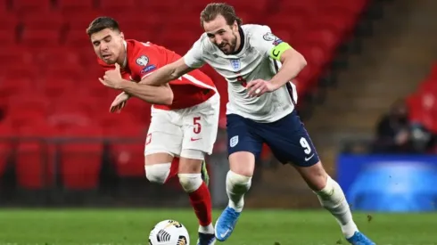 Jan Bednarek of Poland (left) fights for ball control against Harry Kane of England (right) (Getty)