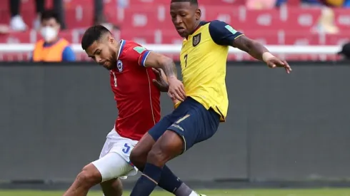 Paulo Díaz of Chile (left) fights for ball possession against Pervis Estupiñan of Ecuador