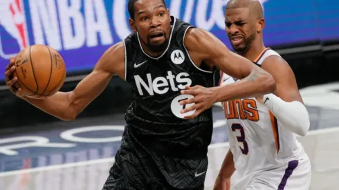 Kevin Durant of Brooklyn Nets (left) tries to pass drible Chris Paul of Phoenix Suns