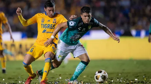 Juan Vigon of Tigres fights for the ball with Osvaldo Rodriguez of Leon.