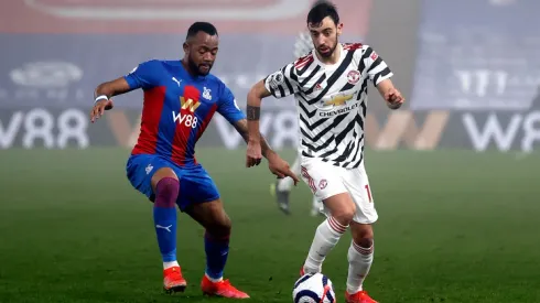 Jordan Ayew of Crystal Palace (left) fights for ball control against Bruno Fernandes of Manchester United