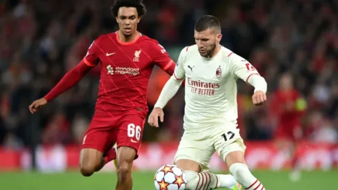 Trent Alexander-Arnold of Liverpool (left) tries to stop Ante Rebic of AC Milan