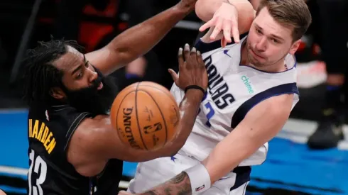 James Harden of Nets (left) fights the ball possession with Luka Doncic of Mavericks