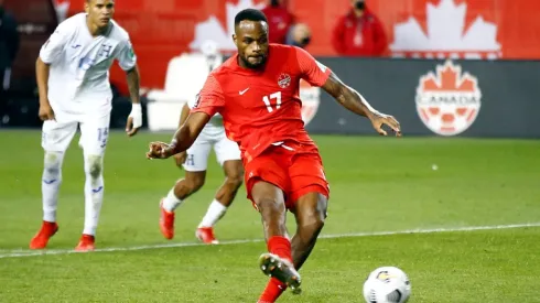 Cyle Larin #17 of Canada scores a penalty during a 2022 World Cup Qualifying match against Honduras.