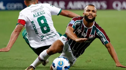 Ribera of Oriente Petrolero fight for ball possession against Xavier of Fluminense