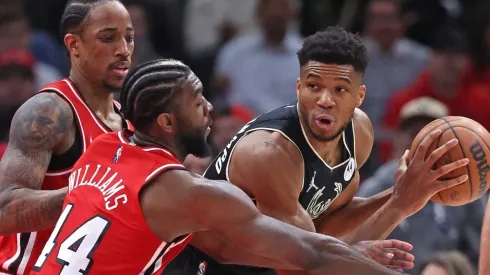 Giannis Antetokounmpo of the Milwaukee Bucks under pressure from DeMar DeRozan and Patrick Williamsof the Chicago Bulls
