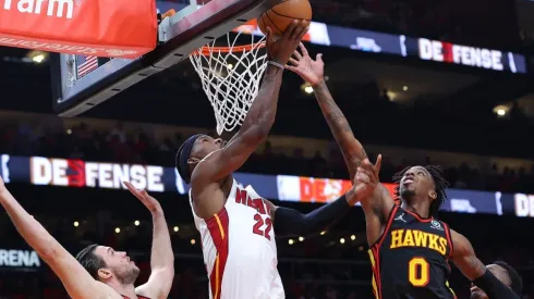 Jimmy Butler of the Miami Heat attacks the basket against Danilo Gallinari and Delon Wright of the Atlanta Hawks
