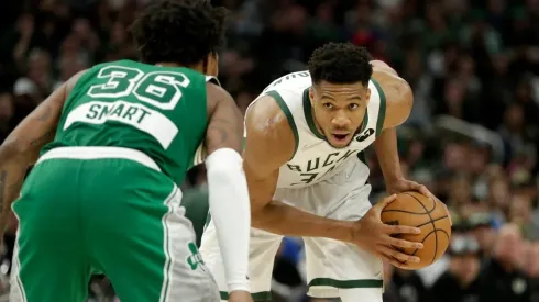 Giannis Antetokounmpo of the Milwaukee Bucks looks to drive on Marcus Smart of the Boston Celtics