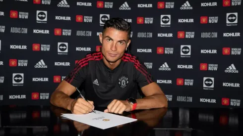 Cristiano Ronaldo of Manchester United poses after signing his contract with the club at Carrington Training Ground on September 08, 2021 in Manchester, England.