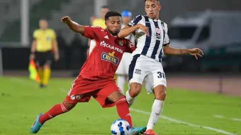 Percy Liza of Sporting Cristal fights for the ball with Matías Godoy of Talleres