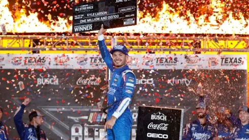 Kyle Larson raises his award for winning the Nascar All-Star Race