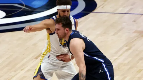 Luka Doncic of the Dallas Mavericks drives past Klay Thompson of the Golden State Warriors