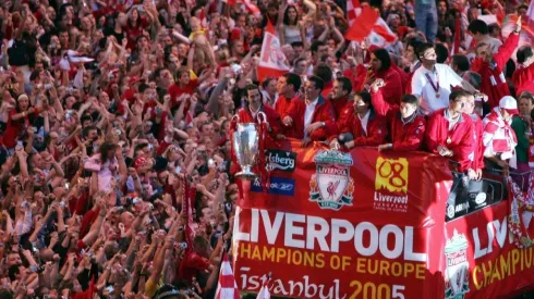 Liverpool team rides on an open top bus through a mass of fans as they arrive at St. George's Hall during the Liverpool Champions League Victory Parade on May 26, 2005