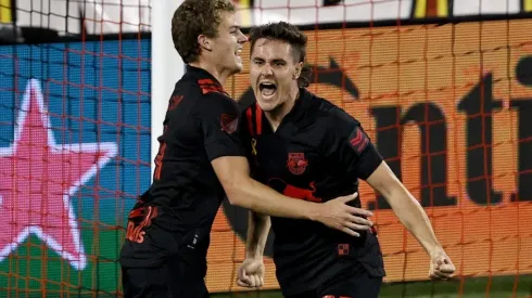 Aaron Long of New York Red Bulls celebrates his goal with teammate Tom Barlow