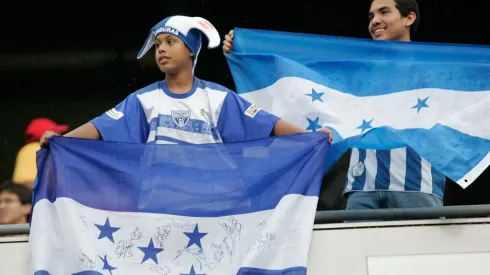 Fans of Honduras hold up flags in support of their team