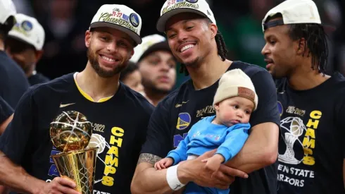 Stephen Curry and Damion Lee of the Golden State Warriors celebrate after defeating the Boston Celtics