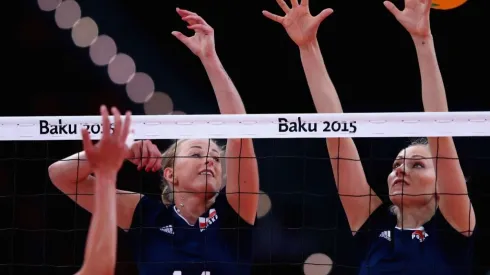 Joanna Wolosz (L) of Poland jumps at the net