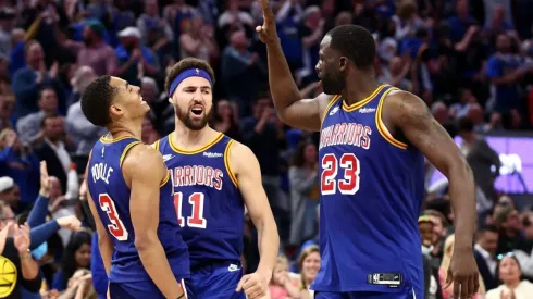 Klay Thompson (c) with Jordan Poole (left) and Draymond Green.