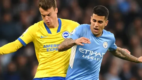 Solly March of Brighton and Joao Cancelo of Manchester City