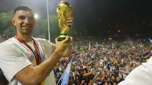 Argentina goalkeeper Emiliano 'Dibu' Martinez with the World Cup trophy in front of the fans.