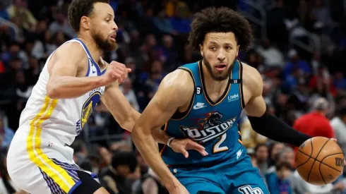 Cade Cunningham of the Detroit Pistons dribbles on Stephen Curry of the Golden State Warriors