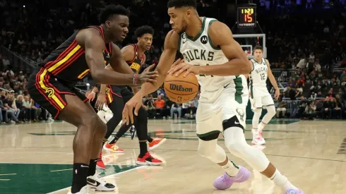 Giannis Antetokounmpo of the Milwaukee Bucks is defended by Clint Capela of the Atlanta Hawks