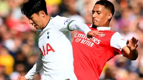 Son Heung-Min of Tottenham is challenged by William Saliba of Arsenal