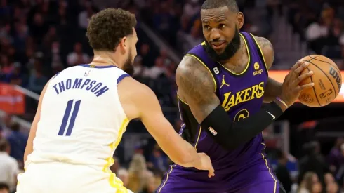 LeBron James #6 of the Los Angeles Lakers is guarded by Klay Thompson #11 of the Golden State Warriors