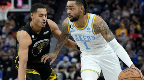 Jordan Poole of the Golden State Warriors and D'Angelo Russell of the Los Angeles Lakers