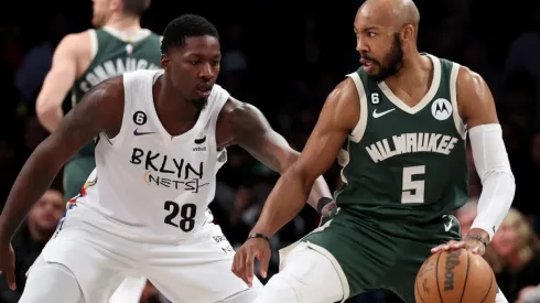 Dorian Finney-Smith of the Brooklyn Nets and Jevon Carter of the Milwaukee Bucks