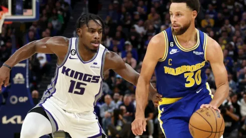 Davion Mitchell of the Sacramento Kings and Stephen Curry of the Golden State Warriors